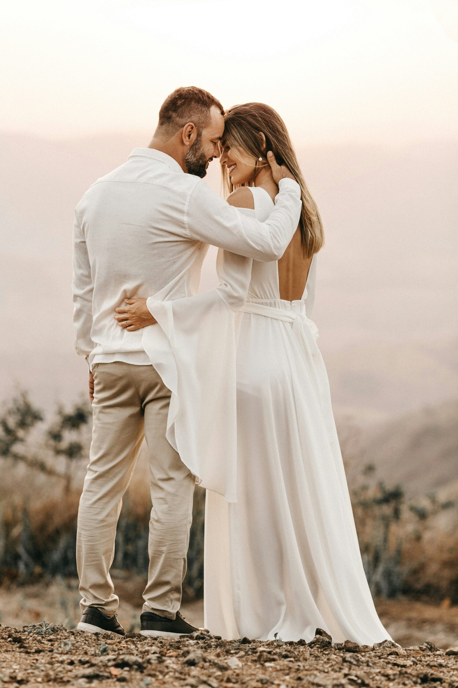 Bride and groom embracing in soft, natural light, perfect for an intimate wedding or elopement.