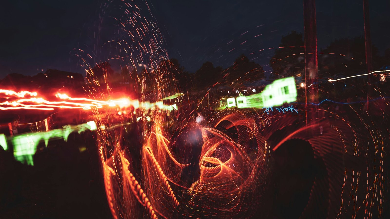 Night event photography with vibrant light trails, capturing an energetic party atmosphere.